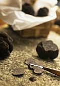 Cutting black truffle into thin slices