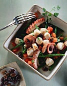 Octopus salad with olives, beans and tomatoes
