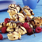 Choux pastries with chocolate icing, raspberries & lavender