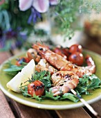Barbecued jumbo prawns with cocktail tomatoes on rocket