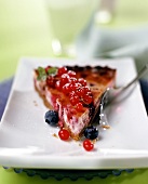 A piece of redcurrant and blueberry tart