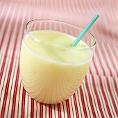 A glass of whey with drinking straw