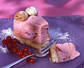 A piece of ice cream gateau with berries on cake plate
