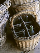 Several empty wine bottles in basket