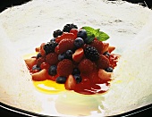 Berry salad with fruit salad in wreath of spun sugar