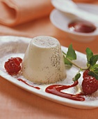 Panna cotta (turned-out cream dessert with raspberry sauce)