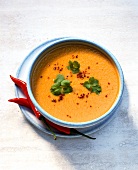 Pumpkin soup, garnished with coriander and chili