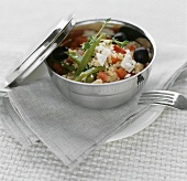 Couscous salad, vegetables & sheep's cheese in take-away dish 