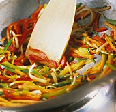 Stir-frying vegetables in the wok