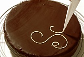 Decorating Sacher torte with writing