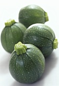 Four round courgettes