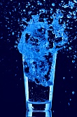 Blue water splashing out of tumbler