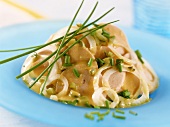 Bavarian sausage salad with onions and chives