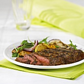 Beef steak with oranges and rocket and onion salad