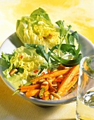 Mixed salad leaves with fried carrots and pine nuts