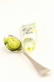 Wasabi (green horseradish paste) in tube and on spoon