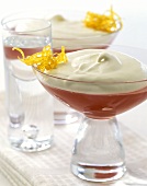 Plum jelly with whipped cream in dessert bowls