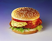 Chicken burger with curry sauce, tomatoes and lettuce