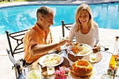 Holiday in Brazil: couple eating Camarao na Moranga
