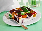 Coconut jelly with pieces of different fruit jellies