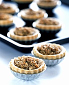 Small nut tartlets in tart tins