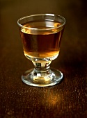 Glass of grog on wooden background