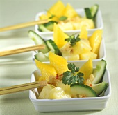 Cucumber salad with mango, pineapple and chili