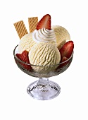 Sundae with vanilla ice cream, strawberries, cream & wafers