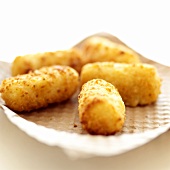 Fritierte Kartoffelkroketten auf Küchenpapier