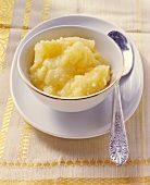 Ghee (clarified butter; India) in small bowl with silver spoon