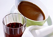 Sauce-boat with gravy, glass of wine