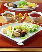 Fondue chinoise with meat, chicken, fish and sauces