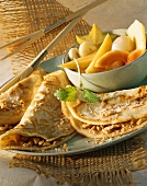 Exotic fruit salad and nut and sesame pancakes