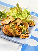 Quail breasts on oak leaf lettuce with nuts and ceps