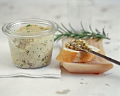 Spreading turkey sausage with herbs in preserving jar
