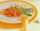 Raw carrot salad with pine nuts and rocket