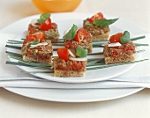 Steak tartare snacks with pesto, tomatoes and basil