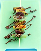 Colourful fruit kebabs with chocolate