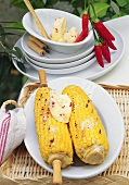 Barbecued corncobs with chili and honey butter