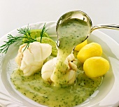 Pouring dill sauce over steamed monkfish