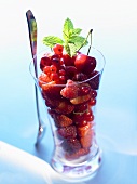 Berry salad with cherries in glass