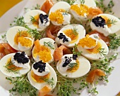 Boiled eggs garnished with salmon and caviare (close-up)