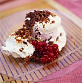 Ice cream dessert with redcurrants, cream & grated chocolate