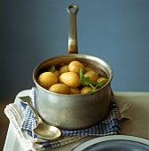 Potatoes with skins in a pan