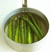 Green asparagus spears in a pan