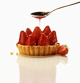 Coating strawberry tart with red cake glaze