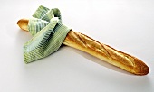 A baguette with a kitchen cloth