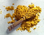 Ground turmeric with wooden spoon