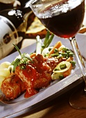 Pork ragout with tomato sauce & vegetables; glass of red wine