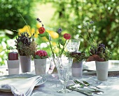Table laid in shades of delicate violet on garden terrace